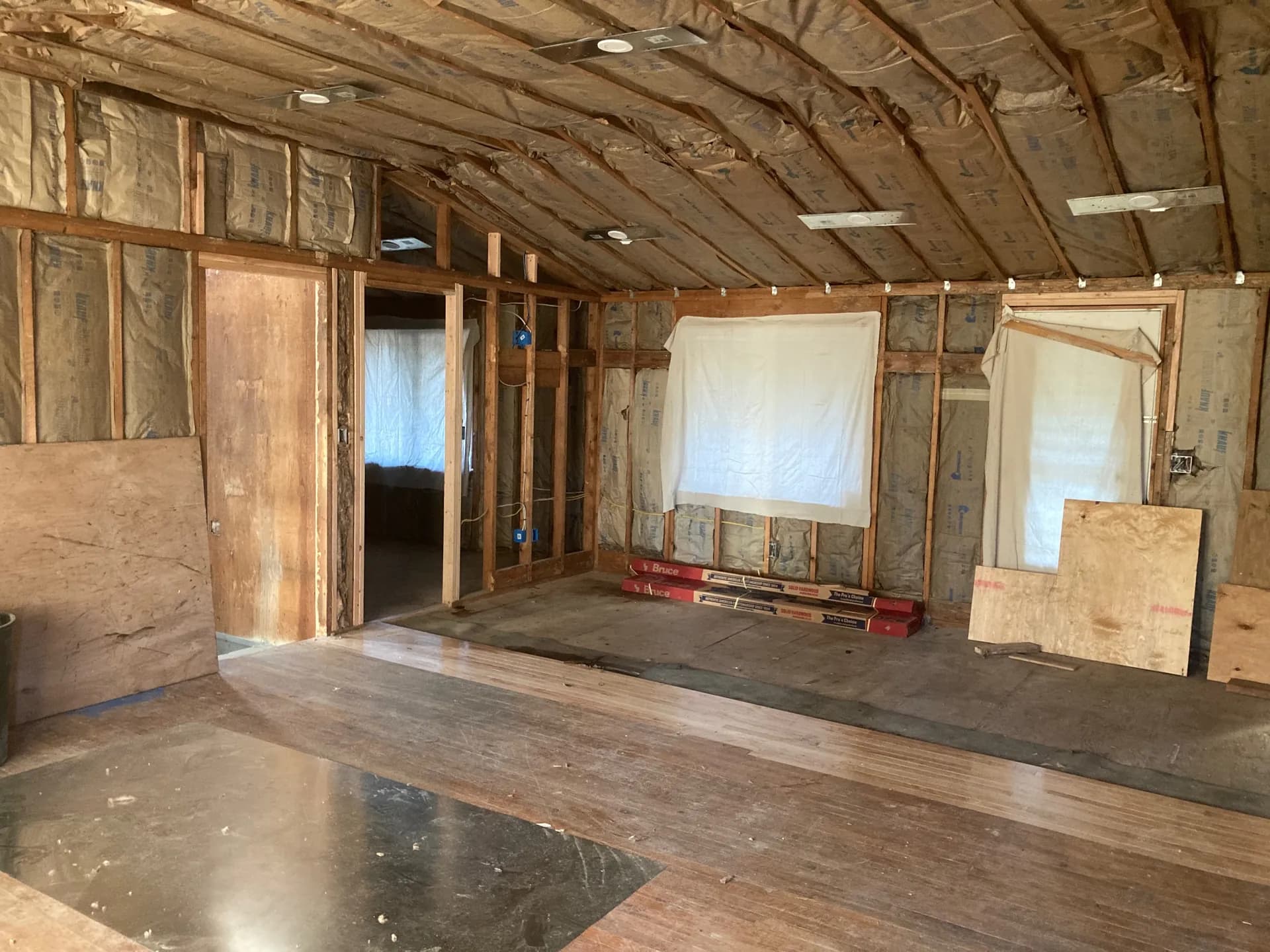 Installer placing fiberglass batt insulation between attic joists